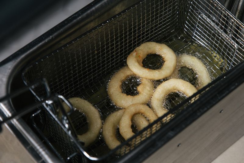 Golden crispy beer-battered onion rings with dipping sauce